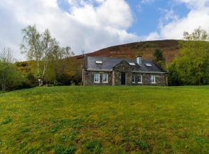 a house on a hill with a green field at An Charraig in Killarney