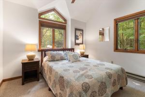 a bedroom with a bed and two windows at Split Rock Classic Chalet – Game Room & Family Friendly in Pocono Pines