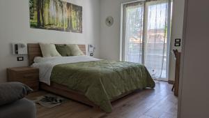 a bedroom with a bed and a large window at AURA MARINA - Guest House Fiumicino in Fiumicino