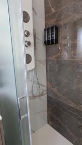 a shower with a glass door in a bathroom at AURA MARINA - Guest House Fiumicino in Fiumicino +17 photos