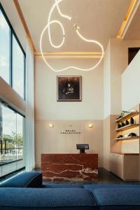 a living room with a couch and a chandelier at Brada Collection Stays in Guadalajara