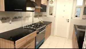 a kitchen with a stove and a counter top at Beach star residency 2 in Muscat +5 photos