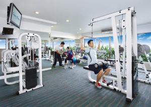 a gym with people exercising on tread machines at Centre Point Pratunam in Bangkok