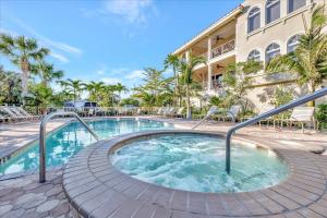 a hot tub in front of a building at 3B Beachfront Condo - Heated Pool & 18ft Balcony in Holmes Beach