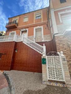 a house with a white gate in front of it at Apartamento nora in Ceuta