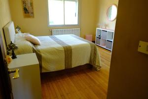 a small bedroom with a bed and a window at Casa Rural Barxa in Monforte de Lemos