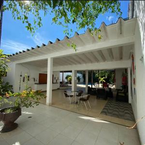 an outdoor patio with a white pergola at Hotel Amazonas Real in Leticia