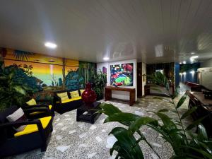 a living room filled with furniture and plants at Hotel Amazonas Real in Leticia