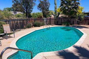 a small swimming pool in a yard with a fence at Tranquil Trail #6 in Carefree