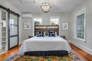 a bedroom with a large bed with blue pillows at Historic Downtown Marble Falls- 2 Suite Combo 13 in Marble Falls