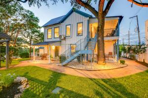 a house with a blue staircase in a yard at Historic Downtown Marble Falls- 2 Suite Combo 13 in Marble Falls