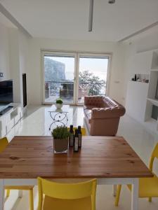 a living room with a wooden table and a couch at White Stylish Apartment 4 in Vico Equense