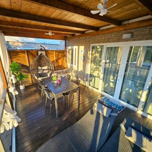 a wooden deck with a table and chairs on a porch at Mobile House 4 you, Murter - Slanica in Murter