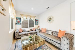 a living room with a couch and a table at Casa Whimsy in Indio