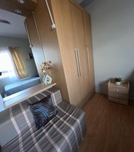 a small bedroom with a bed and a cabinet at Mivesa Garden Residences Lahug in Cebu City +10 photos
