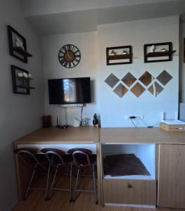a desk in a room with two stools and a tv at Mivesa Garden Residences Lahug in Cebu City