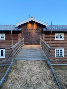 a large wooden building with a large wooden door at Stall-loftet, Aastrøen gård, Vingelen in Vingelen