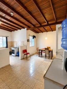 a kitchen and dining room with a table and chairs at Hostel & Coffe Bahia in Porto Alegre