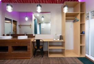 a bathroom with a desk and a sink and a mirror at Ukulhas Villa Hotel & Spa in Ukulhas +127 photos