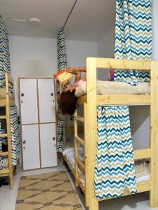 a person laying on a bunk bed in a room at Zalooma House I Beachfront Hostel Dahab in Dahab