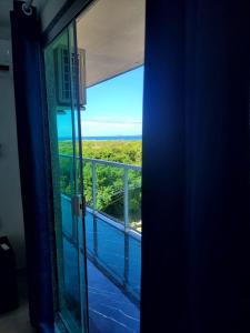 a room with a view of the ocean from a balcony at terraço do peró cabo frio pousada in Cabo Frio
