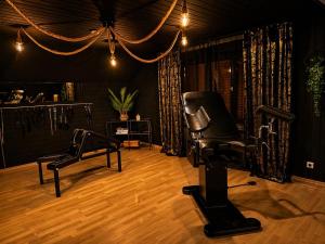 a salon with a black chair and a hair salon at Emotion Apartments- BDSM Apartment mit privater Sauna in Vlotho