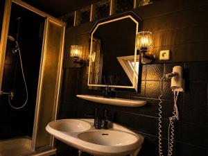 a bathroom with a sink and a mirror at Emotion Apartments- BDSM Apartment mit privater Sauna in Vlotho