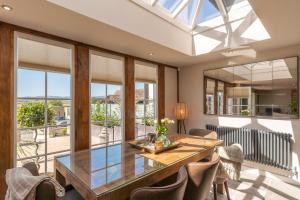 a dining room with a glass table and chairs at Cedar Lodge Severn Stoke in Severn Stoke