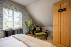 a bedroom with a bed and a window and a chair at Cedar Lodge Severn Stoke in Severn Stoke +47 photos
