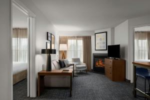 a hotel room with a bed and a living room at Residence Inn Boise West in Boise