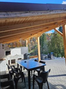 a wooden table and chairs on a patio at Vibe House Madisson in Braşov