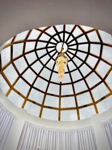 a glass ceiling with a chandelier hanging from it at Kings Castle in Varkala