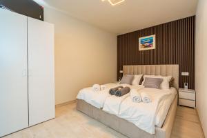 a bedroom with a large bed with towels on it at Apartman Mirakul 2 in Korčula +26 photos