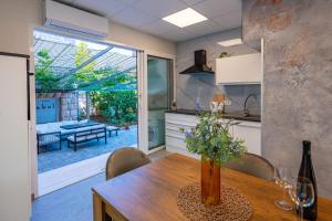 a kitchen with a wooden table with a vase on it at Apartman Mirakul 2 in Korčula