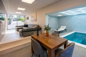 a living room with a table and a swimming pool at Apartman Mirakul 2 in Korčula