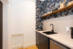 a kitchen with a sink and a counter top at Sienna Central Studio & Parking in Warsaw +8 photos