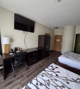 a hotel room with a desk and a bed and a television at Austinburg Hotel in Austinburg