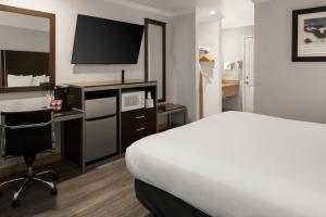 a hotel room with a bed and a desk at Sand Castle Inn in Seaside