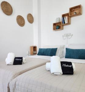 two beds with pillows on them in a room at Kato Yialos Paros in Parikia