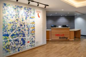 an office with a hello reopening sign on a wall at TownePlace Suites Redding in Redding +56 photos
