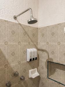 a bathroom with a shower with a light on the wall at Casa Palagui Colonial in Valladolid +132 photos