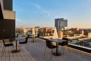 a group of tables and chairs on the roof of a building at Four Points Flex by Sheraton Madrid Atocha in Madrid
