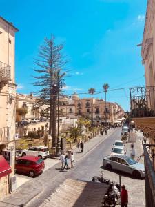 a city street with cars parked on the road at Lùrooms- Guesthouse in Noto in Noto
