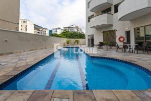 a swimming pool in a building with blue water in aominium at Lobie Botafogo Privilege in Rio de Janeiro