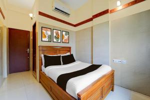 a bedroom with a large bed in a room at Hotel O Stay First in Coimbatore