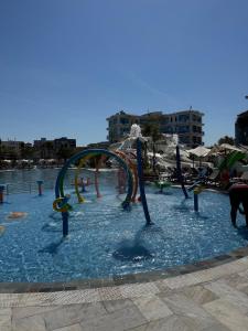 a water park with a roller coaster in the water at Dengu Luxury Apartments in Golem