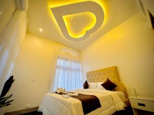 a bedroom with a bed with a yellow light on the ceiling at Kings Castle in Varkala