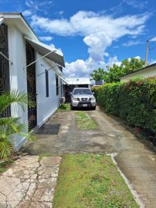 a car parked in the driveway of a house at 14 Zeneith Avenue in Harbour View