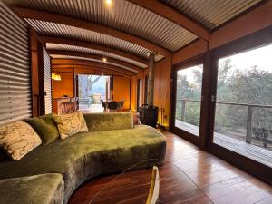 a living room with a couch and a large window at The Odd Frog in Bright