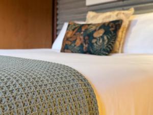 a close up of a bed with a pillow at The Odd Frog in Bright
